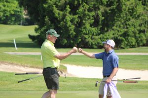 2026 Senior Mid-Am Team - Charles Pattan and Alex Finserwald celebrate a chip in by Pattan